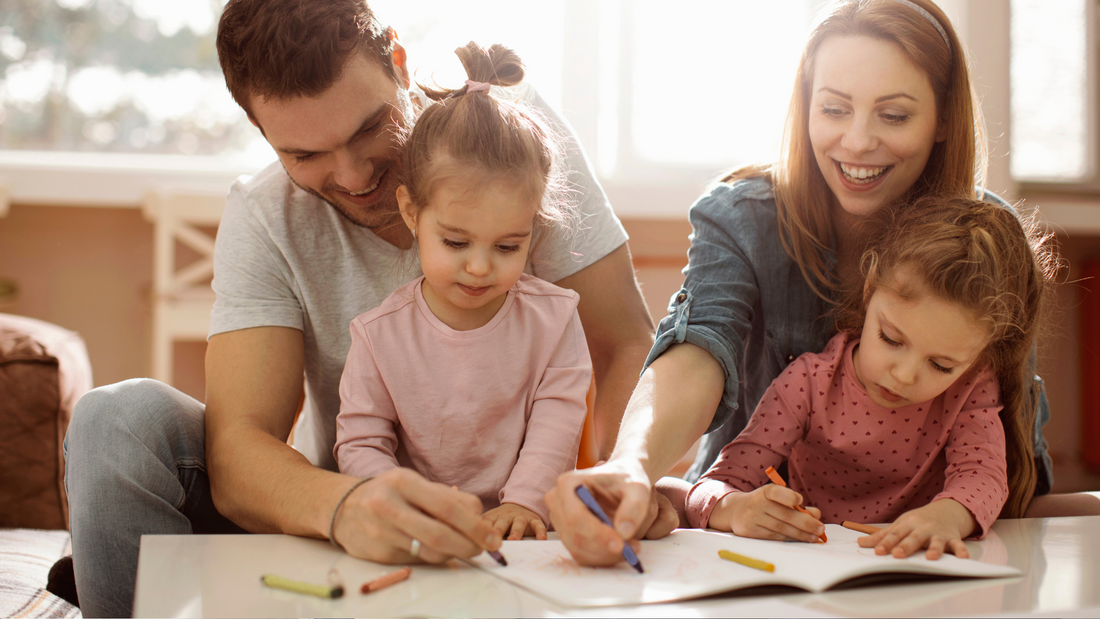 Parents supporting young children with creative activities at home – nurturing focus and calm in kids with ADHD through structured routines and bonding time.