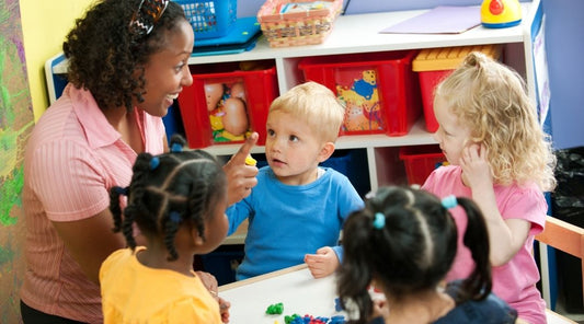 Teacher guiding preschoolers with ADHD and sensory challenges through structured learning activities.